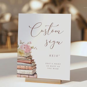Puede incluir: Un cartel blanco con el texto "Custom Sign" en letra cursiva marrón. El cartel está decorado con una ilustración de acuarela de una pila de libros con flores rosas y amarillas. El cartel también incluye el texto "8x10" y "Edit & Print as many as you wish".