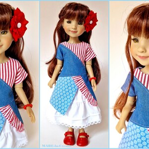May include: A doll wearing a red and white striped shirt with a denim overlay and a blue and white floral print skirt. The doll has long red hair and is wearing a red flower hair accessory.