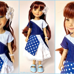 May include: A doll wearing a blue and white dress with polka dots and a white flower in her hair.