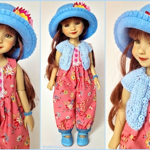 Könnte beinhalten: Eine Puppe mit langem braunem Haar trägt einen hellblauen Filzhut mit gelben und rosa Blumen, eine hellblaue Strickjacke mit drei Knöpfen und einen rosa geblümten Overall mit weißer Spitzenborte und drei rosa Knöpfen am Oberteil.