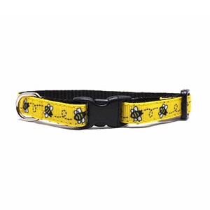 May include: Yellow and black pet collar with a bee pattern. The collar has a black plastic buckle and a metal D-ring. The bee pattern is a repeating design of yellow bees on a yellow background.