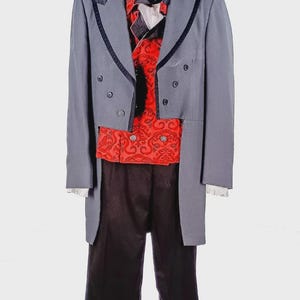 May include: A formal grey suit with black trim, a red patterned waistcoat, and black trousers. The outfit includes a black bow tie, a white collared shirt, and a black top hat. A vintage costume.