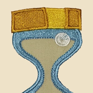 May include: A blue and gold embroidered hourglass patch. The hourglass is filled with sand and has a white circle at the top and bottom.