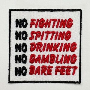 May include: A square embroidered patch with a white background and a black border. The text is stitched in black and red thread, listing five rules: NO FIGHTING, NO SPITTING, NO DRINKING, NO GAMBLING, and NO BARE FEET, each starting with NO in black.