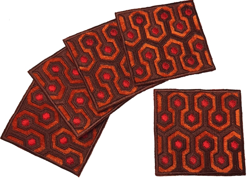 May include: Set of six brown and orange coasters with a red geometric pattern. The pattern resembles the carpet from the movie "The Shining".