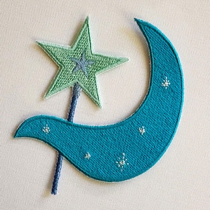 May include: An embroidered patch featuring a teal crescent moon with small white stitched stars and a light green five-pointed star attached to a dark blue wand handle. The design uses dense thread work to create a textured, celestial-themed graphic.