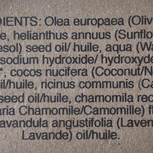 Puede incluir: Un primer plano de una etiqueta de producto que enumera los ingredientes de una pastilla de jab&oacute;n. Los ingredientes se enumeran en ingl&eacute;s y franc&eacute;s. Los ingredientes incluyen aceite de oliva, aceite de semilla de girasol, agua, hidr&oacute;xido de sodio, aceite de coco, aceite de ricino, flor de manzanilla y aceite de lavanda.