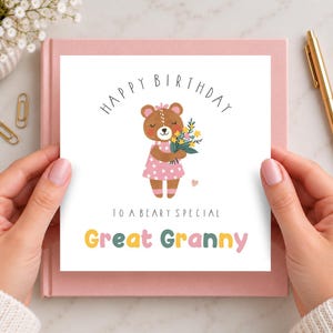 May include: A square birthday greeting card featuring a brown bear illustration wearing a pink dress with white stars, holding a bouquet of yellow and blue flowers. The text reads Happy Birthday to a beary special Great Granny in colorful letters.