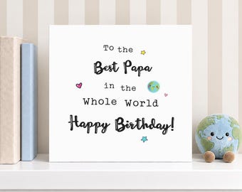 May include: A square white greeting card with black text that reads To the Best Papa in the Whole World Happy Birthday. The card features small colorful illustrations of a smiling planet Earth, a pink heart, and yellow and blue stars.