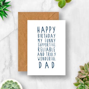 May include: A white card with a blue inscription that reads "Happy Birthday My Funny Supportive Reliable And Truly Wonderful Dad". The card is sitting on a brown envelope.