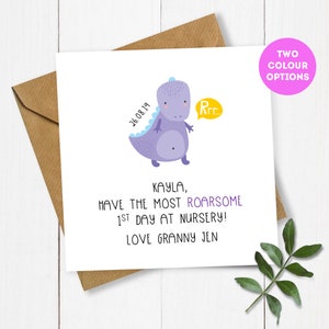 May include: A purple dinosaur with a speech bubble that says "Rrr" on a white card with the text "26.08.19 Kayla, Have the most roarsome 1st day at nursery! Love Granny Jen"