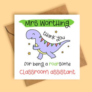 May include: A square greeting card featuring a purple dinosaur illustration with red and green triangular bunting on its back. The text reads: Mrs Worthing thank you for being a roarsome classroom assistant. The card is placed on a brown envelope.