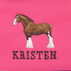 May include: Pink canvas tote bag with an embroidered brown and white horse and the name "KRISTEN" in black.