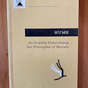 May include: A yellow book cover with black text that reads "BOBBS-MERRILL THE LIBRARY OF LIBERAL ARTS HUME An Inquiry Concerning the Principles of Morals 85¢".