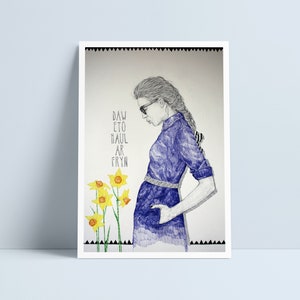May include: A black and white drawing of a person wearing a purple dress and sunglasses. The person is standing next to a cluster of yellow daffodils. The text "DAW ETO HAUL AR FRYN" is written on the left side of the image.