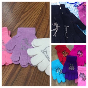 May include: Assortment of fingerless gloves with various designs. The gloves are made of a soft, knitted fabric and feature different embellishments, including rhinestones, glitter, and embroidered images. The designs include a pineapple, a unicorn, a skater, and a bird.