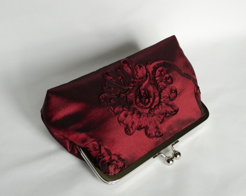 burgundy and gold clutch bag