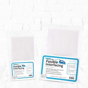 May include: Two packages of white fusible interfacing with blue and white labels. The labels read "Fusible Interfacing" and include text about adding strength and crispness to fabrics. The packages are for sewing and quilting.