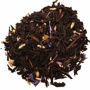May include: A close-up of a blend of black tea leaves with dried lavender and cornflower petals.