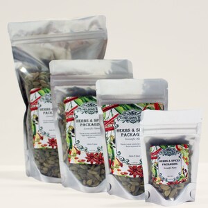 May include: Three silver resealable bags filled with green cardamom pods. The bags are labeled "Herbs & Spices Packaging" with the company name "The Nelsons Tea Co."