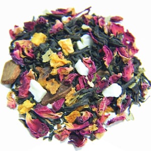 May include: A blend of black tea, dried fruit, rose petals, and white sugar crystals. The tea is a mix of dark green and black tea leaves, with orange and yellow dried fruit pieces, pink rose petals, and white sugar crystals.