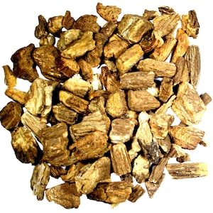 May include: A close-up of a pile of dried, brown, and beige root pieces. The root pieces are irregularly shaped and have a rough texture.