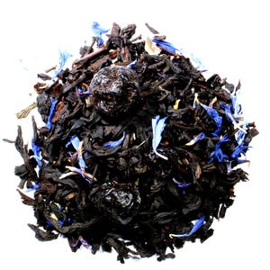 May include: A close-up of a blend of black tea leaves, dried blueberries, and cornflower petals.