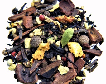 May include: A close-up of a blend of black tea leaves, spices, and dried fruit. The tea blend includes cinnamon sticks, cloves, star anise, cardamom pods, and orange peel.