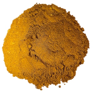 May include: A close-up of a pile of ground turmeric powder, a bright yellow-orange color.