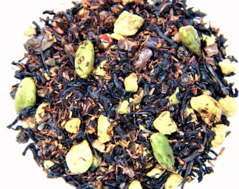 May include: A blend of black tea, chocolate, and candied ginger with cardamom pods. The tea is a dark brown color and the ginger pieces are a light yellow color.