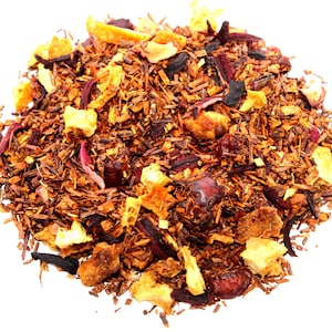 May include: A close-up of a blend of red rooibos tea with dried orange peel, cranberries, and hibiscus flowers.