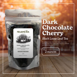 May include: A clear plastic bag filled with dark loose leaf tea. The bag has a label that reads "Nelson's Tea" and "Dark Chocolate Cherry". The label also includes the ingredients: Pu-erh black tea, chocolate chips, cacao nibs, hibiscus, wild cherry bark, dried cherries, safflower and natural flavoring. The bag is labeled "2 ounces".