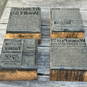 May include: Four vintage wooden printing blocks with black ink. The blocks advertise products such as "Remove Warts!" and "Women Past 21 with Bladder Irritation".
