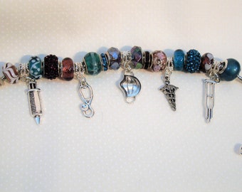 Nurse European charm bracelet Murano purples and teal beads syringe, stethoscope, crutch, Mask, you pick Caduceus. Help save a cat/kitten