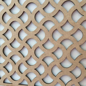May include: A brown wooden panel with a repeating pattern of cut-out teardrop shapes. The panel has a light brown wood grain.