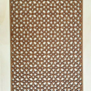 May include: A brown wooden decorative panel with a geometric pattern of interlocking circles and squares.