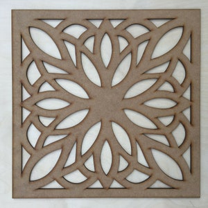May include: A brown wooden square panel with a decorative cutout design. The design features a repeating pattern of leaves and swirls.