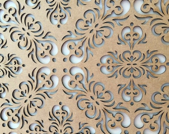 May include: A brown wooden panel with a decorative cut-out design featuring intricate swirls and floral patterns.