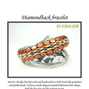 May include: A close-up of a copper and silver beaded bracelet with a diamondback pattern. The bracelet is on a clear glass surface. The text "Diamondback bracelet" is at the top of the image. The text "IN ENGLISH" is below the bracelet. The text "Stitch a chunky bracelet with seed beads and two-hole beads like GemDuos and Ginko beads. In focus are the Kaparia Cymbal Elements that shapes both the bracelet and the pattern on top. The Kaparia Cymbal Elements builds the structure and are crucial for the original design. However, if you have trouble finding them, you have not one - but two - different ways of beading the bracelet without them." is below the image.
