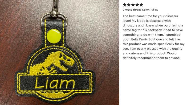 May include: Black and yellow embroidered keychain with a dinosaur design and the name "Liam". The keychain has a metal clasp and a yellow button. The text "Choose Thread Color: Yellow" is also visible.