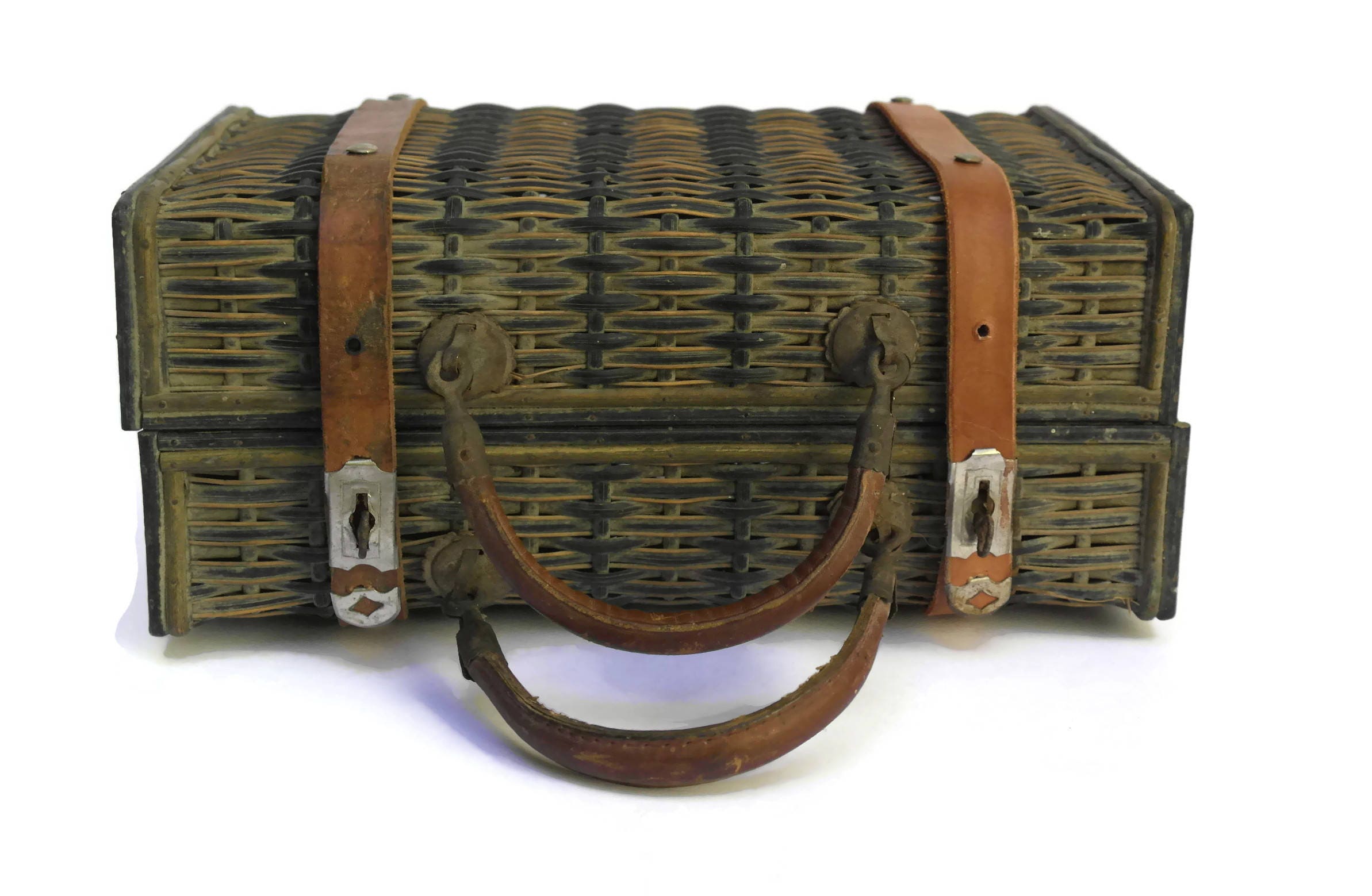 Antique Wicker Basket Suitcase with Brown Leather Straps and Handles.