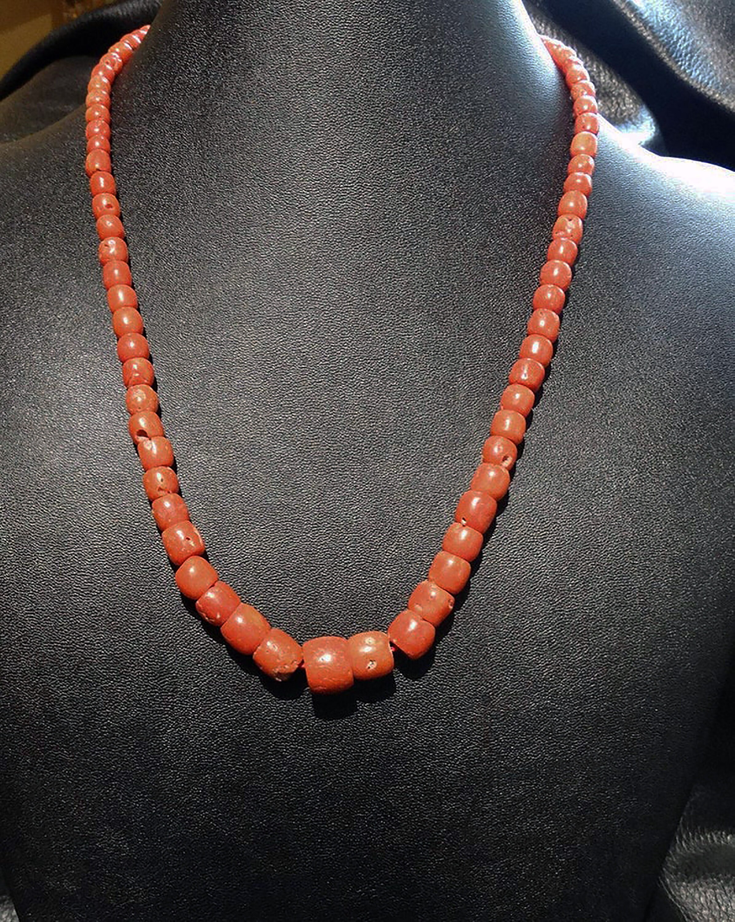 Lot 656 - Antique coral bead necklace with a string of