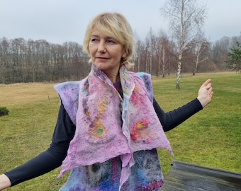 May include: A woman wearing a purple, blue, and yellow felted scarf with a colorful abstract design. The scarf is worn as a vest.