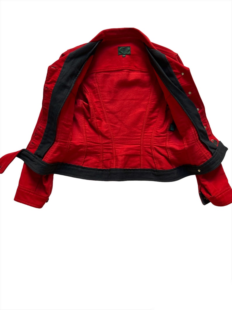 May include: Red denim jacket with black lining and gold buttons. The jacket is unzipped and turned inside out.