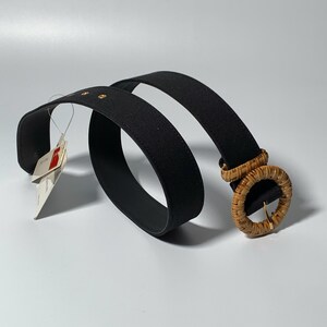 May include: A black woven belt with a large, round, natural woven buckle.