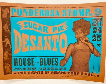 May include: A vintage concert poster for Sugar Pie Desanto performing at the House of Blues in New Orleans. The poster is brown with blue and black text. The poster features a photo of Sugar Pie Desanto singing into a microphone. The poster advertises the event as "Ponderosa Stomp No. 9" and states that the event will take place on September 24th and 25th. The poster also states that the event will feature "Two Nights of Insane Rock N Roll."