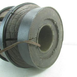 May include: A large wooden wheel with a metal rim. The wheel is made of dark wood and has a diameter of approximately 12 inches. The metal rim is black and has a diameter of approximately 14 inches. The wheel is in good condition and has a few minor scratches.