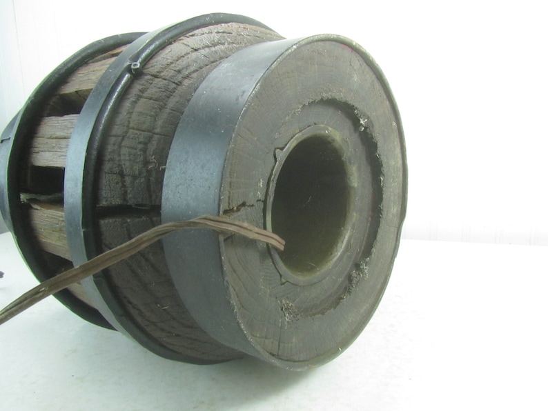 May include: A large wooden wheel with a metal rim. The wheel is made of dark wood and has a diameter of approximately 12 inches. The metal rim is black and has a diameter of approximately 14 inches. The wheel is in good condition and has a few minor scratches.