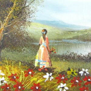May include: A painting of a woman in a pink dress standing in a field of red and white flowers. She is looking out at a lake and mountains in the distance.