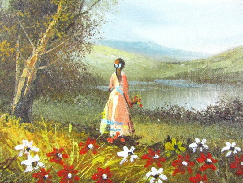 May include: A painting of a woman in a pink dress standing in a field of red and white flowers. She is looking out at a lake and mountains in the distance.